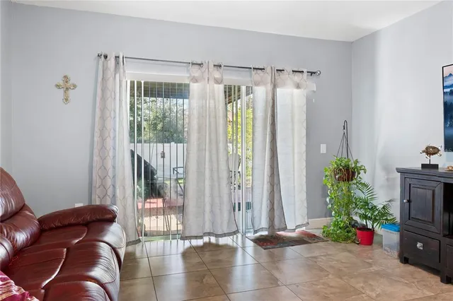 a living room with furniture and flowers