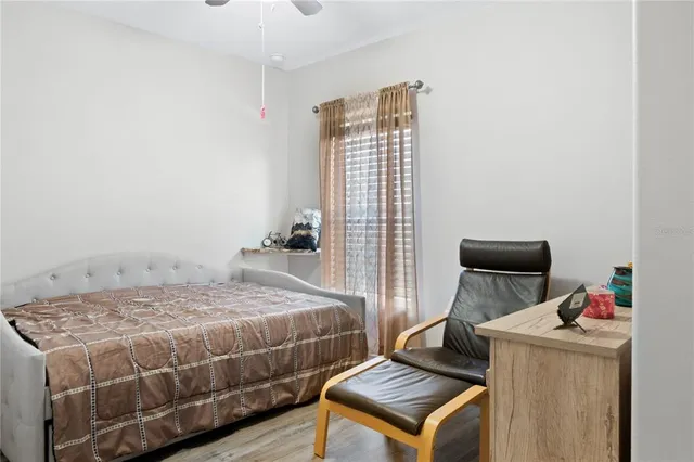 a bedroom with a bed and wooden floor