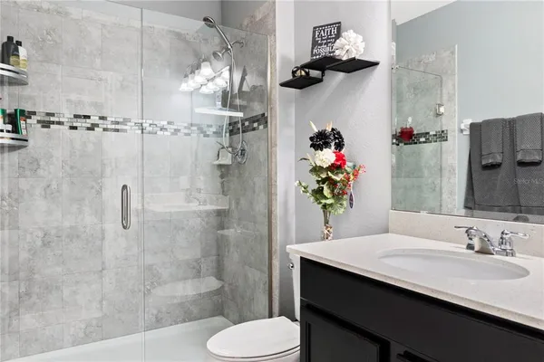 a bathroom with a sink toilet and shower