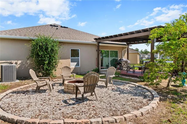 a view of a house with backyard sitting area and garden