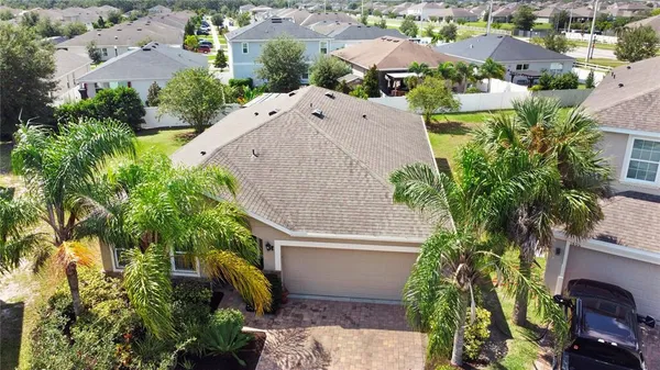 an aerial view of a house with a yard basket ball court and outdoor seating