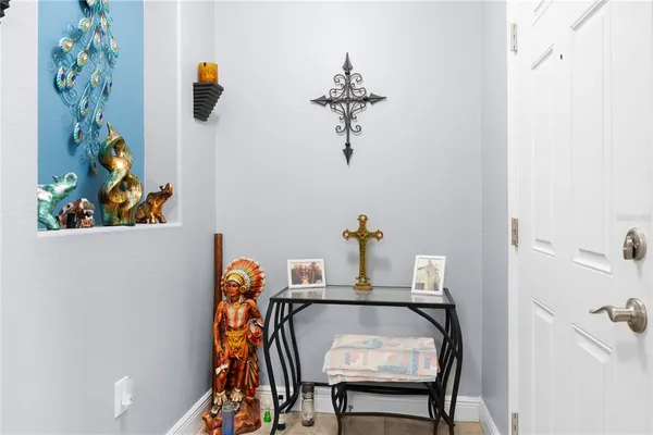 a table with a vase and a mirror on it