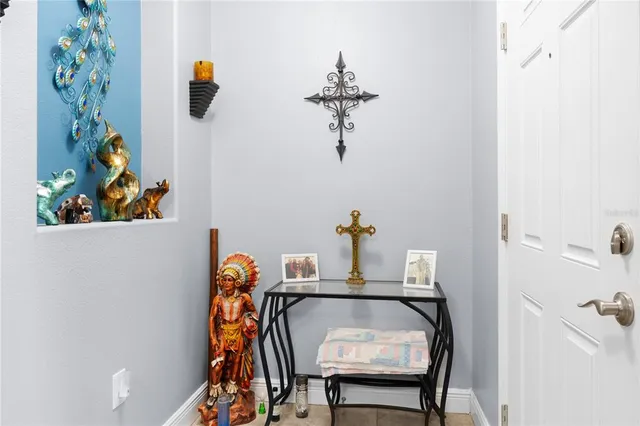 a table with a vase and a mirror on it