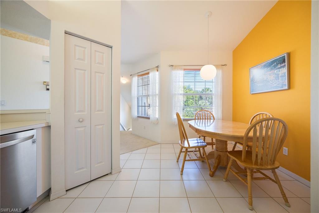 6927 Satinleaf Road North, Unit 203 Naples, FL 34109 - Photo 12 of 39 Dining space featuring light tile patterned flooring and baseboards