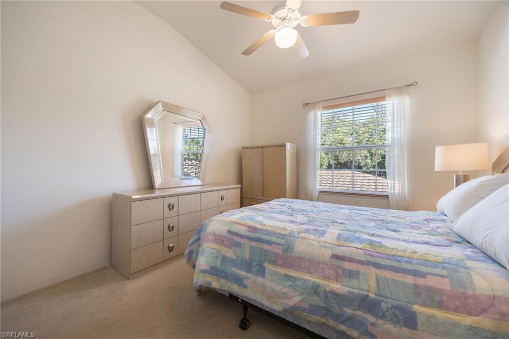 6927 Satinleaf Road North, Unit 203 Naples, FL 34109 - Photo 25 of 39 Carpeted bedroom with lofted ceiling, multiple windows, and ceiling fan