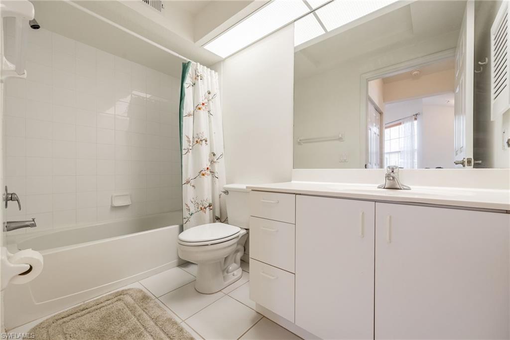 6927 Satinleaf Road North, Unit 203 Naples, FL 34109 - Photo 26 of 39 Full bathroom featuring light tile patterned floors, vanity, and shower / tub combo