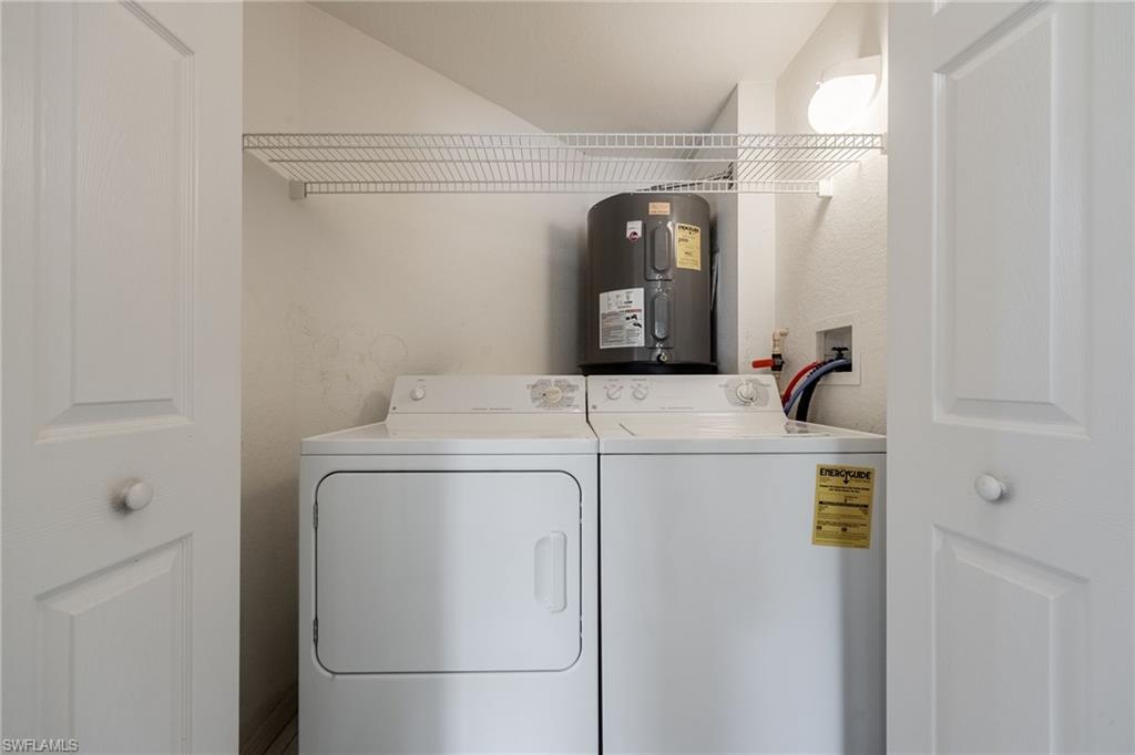 6927 Satinleaf Road North, Unit 203 Naples, FL 34109 - Photo 27 of 39 Laundry room with electric water heater and independent washer and dryer
