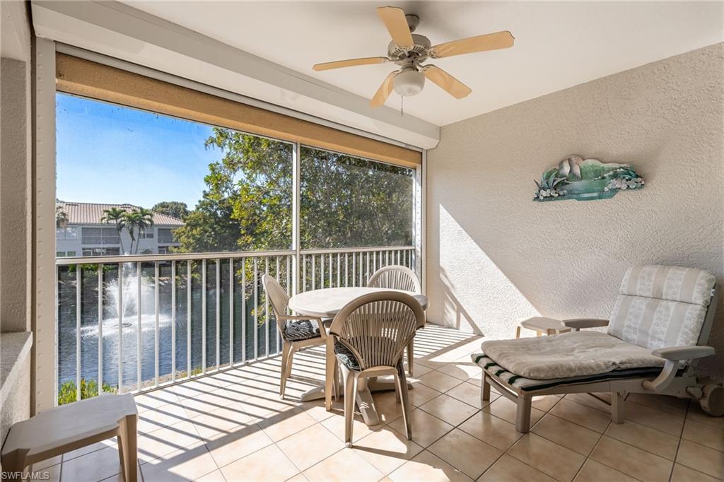 6927 Satinleaf Road North, Unit 203 Naples, FL 34109 - Photo 29 of 39 Sunroom / solarium with ceiling fan, a balcony, and a water view