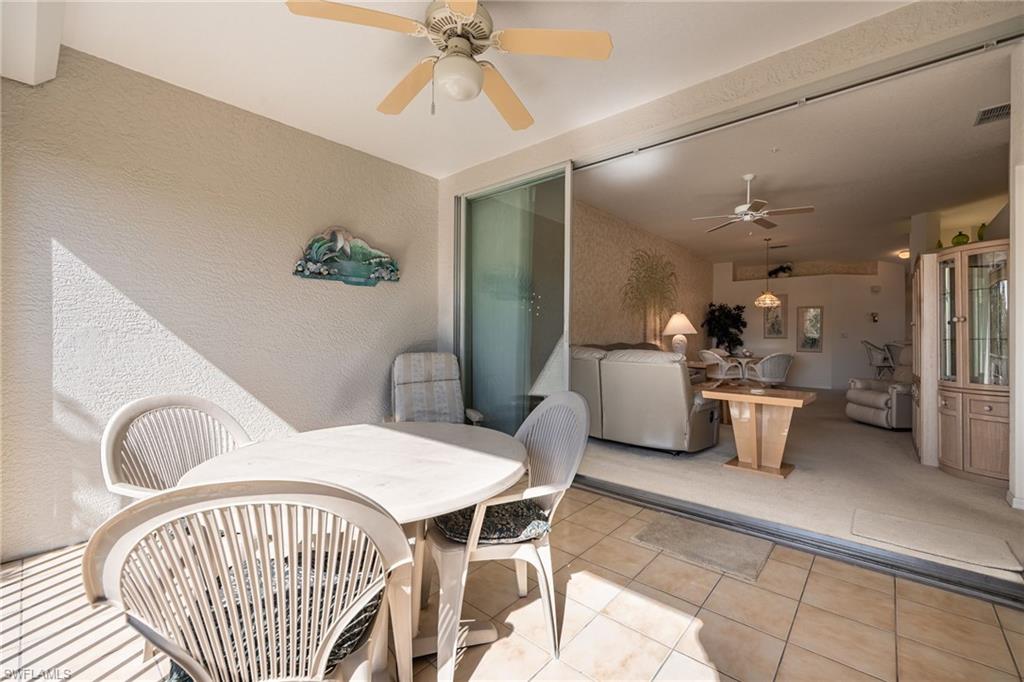 6927 Satinleaf Road North, Unit 203 Naples, FL 34109 - Photo 30 of 39 View of patio / terrace featuring outdoor dining space and ceiling fan