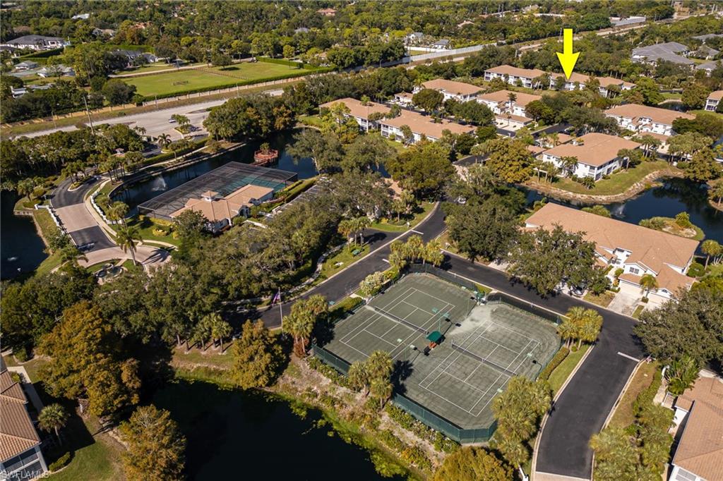 6927 Satinleaf Road North, Unit 203 Naples, FL 34109 - Photo 39 of 39 Aerial view of property and surrounding area with a large body of water