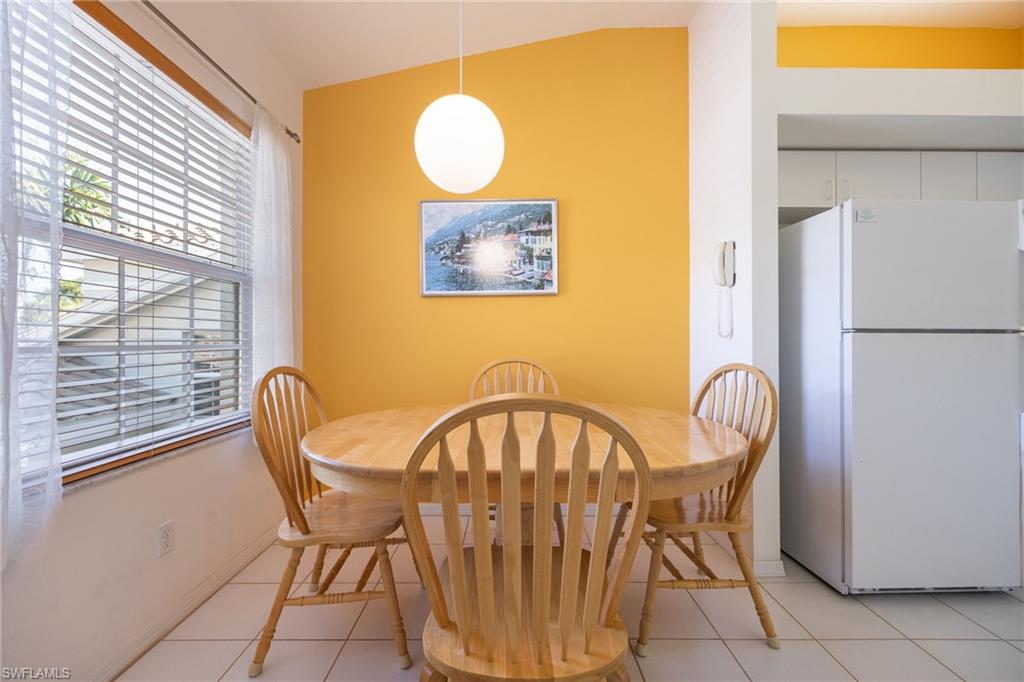 6927 Satinleaf Road North, Unit 203 Naples, FL 34109 - Photo 9 of 39 Dining room featuring light tile patterned flooring and baseboards