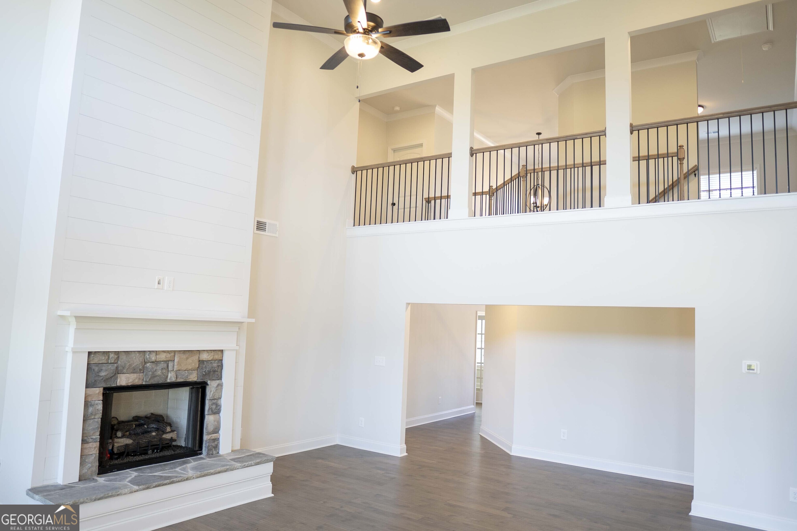 600 Beaver Court Perry, GA 31069 - Photo 12 of 48 a view of an empty room with wooden floor fireplace and a window