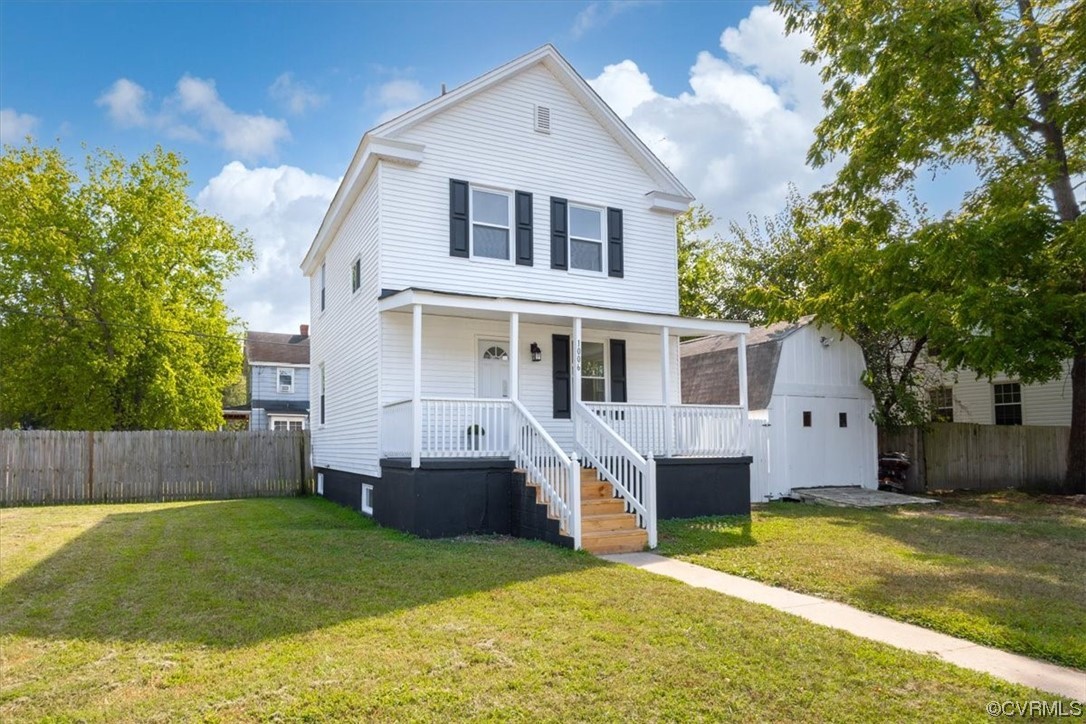 a front view of a house with a yard garage and glass top table and chairs
