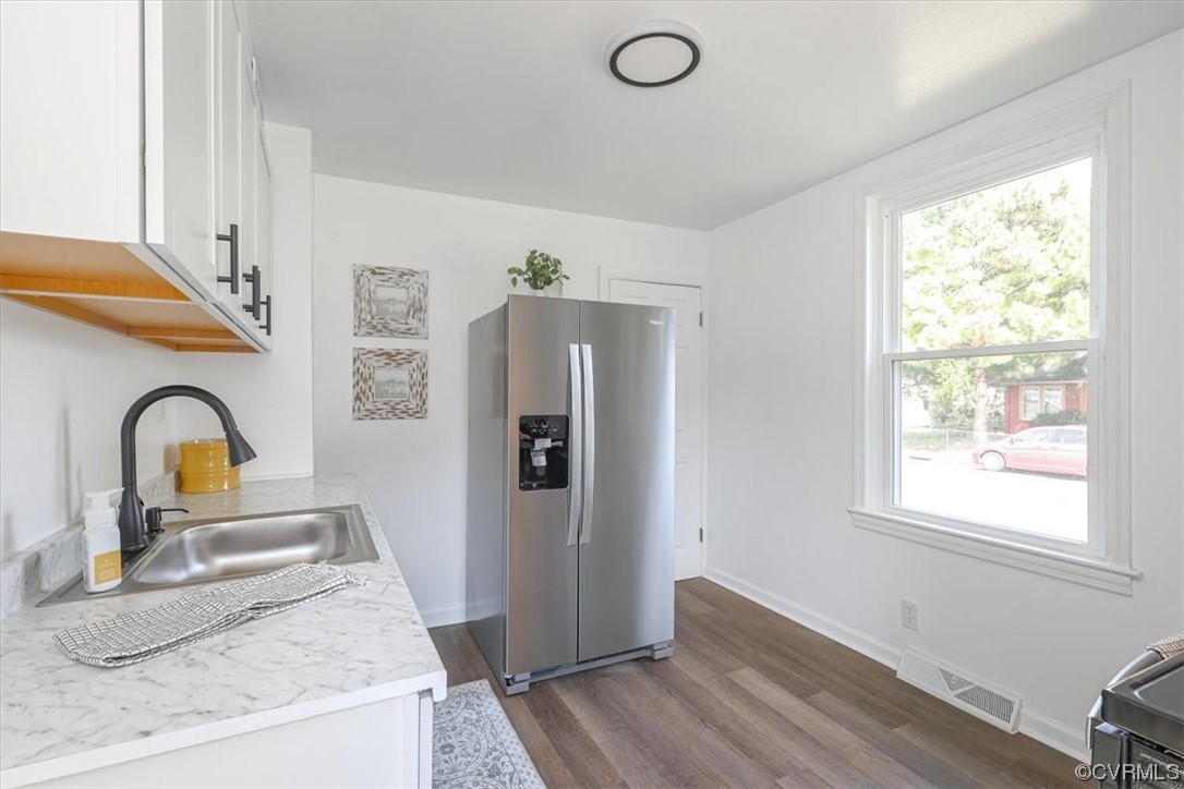 1006 Haskell Street Hopewell, VA 23860 - Photo 17 of 48 a view of a sink and dishwasher with wooden floor