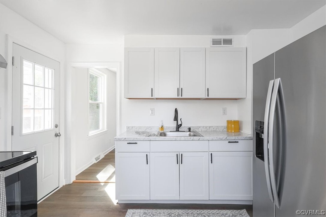 1006 Haskell Street Hopewell, VA 23860 - Photo 18 of 48 a kitchen with stainless steel appliances granite countertop a refrigerator sink and cabinets