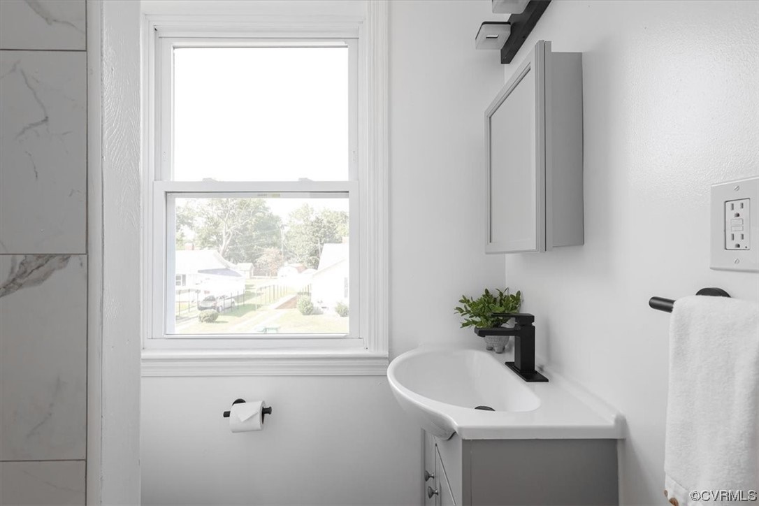 1006 Haskell Street Hopewell, VA 23860 - Photo 34 of 48 a bathroom with a sink a window and a mirror