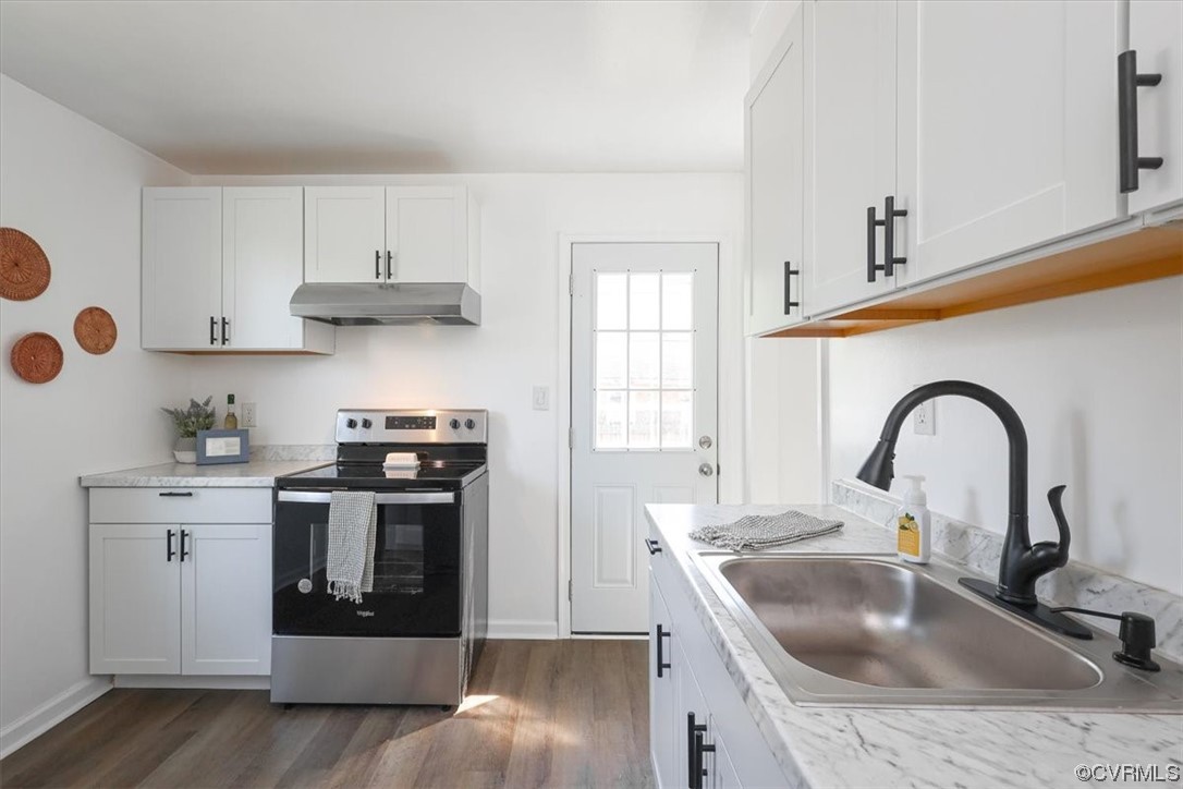 1006 Haskell Street Hopewell, VA 23860 - Photo 8 of 48 a kitchen with stainless steel appliances granite countertop a sink stove and cabinets