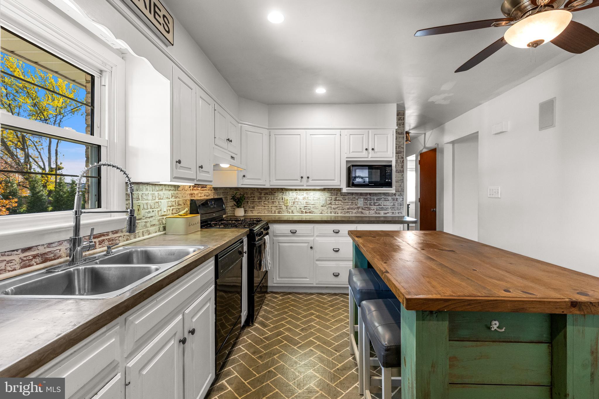 63 Quaker Hills Road Lancaster, PA 17603 - Photo 14 of 52 a kitchen that has a sink and a stove in it