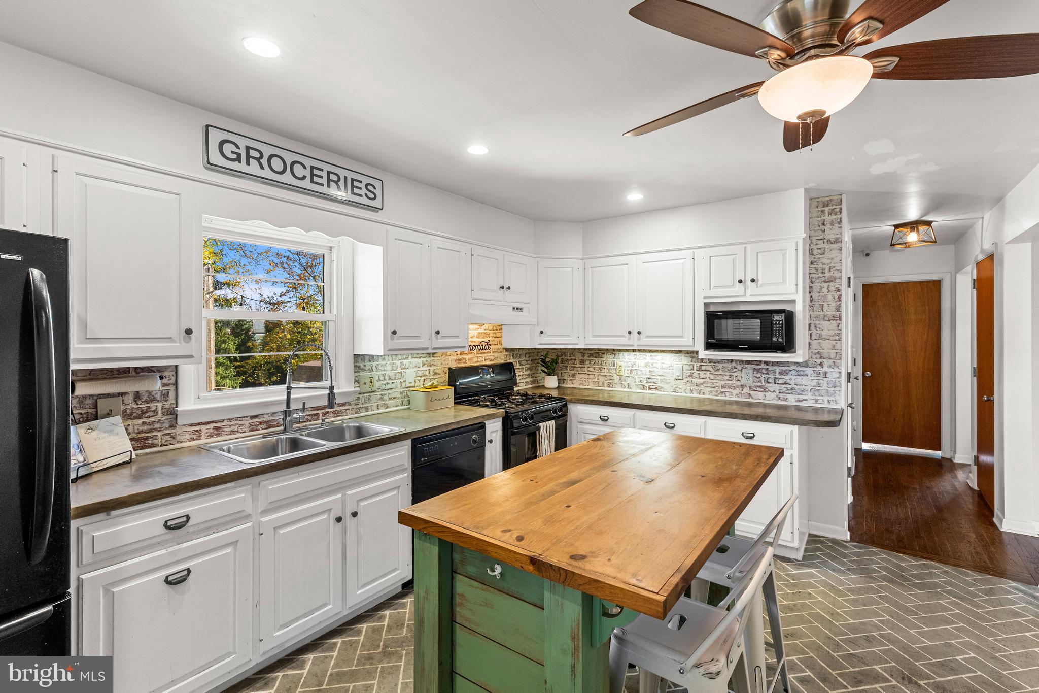 63 Quaker Hills Road Lancaster, PA 17603 - Photo 16 of 52 a kitchen with stainless steel appliances granite countertop a sink a stove a refrigerator cabinets and a dining table