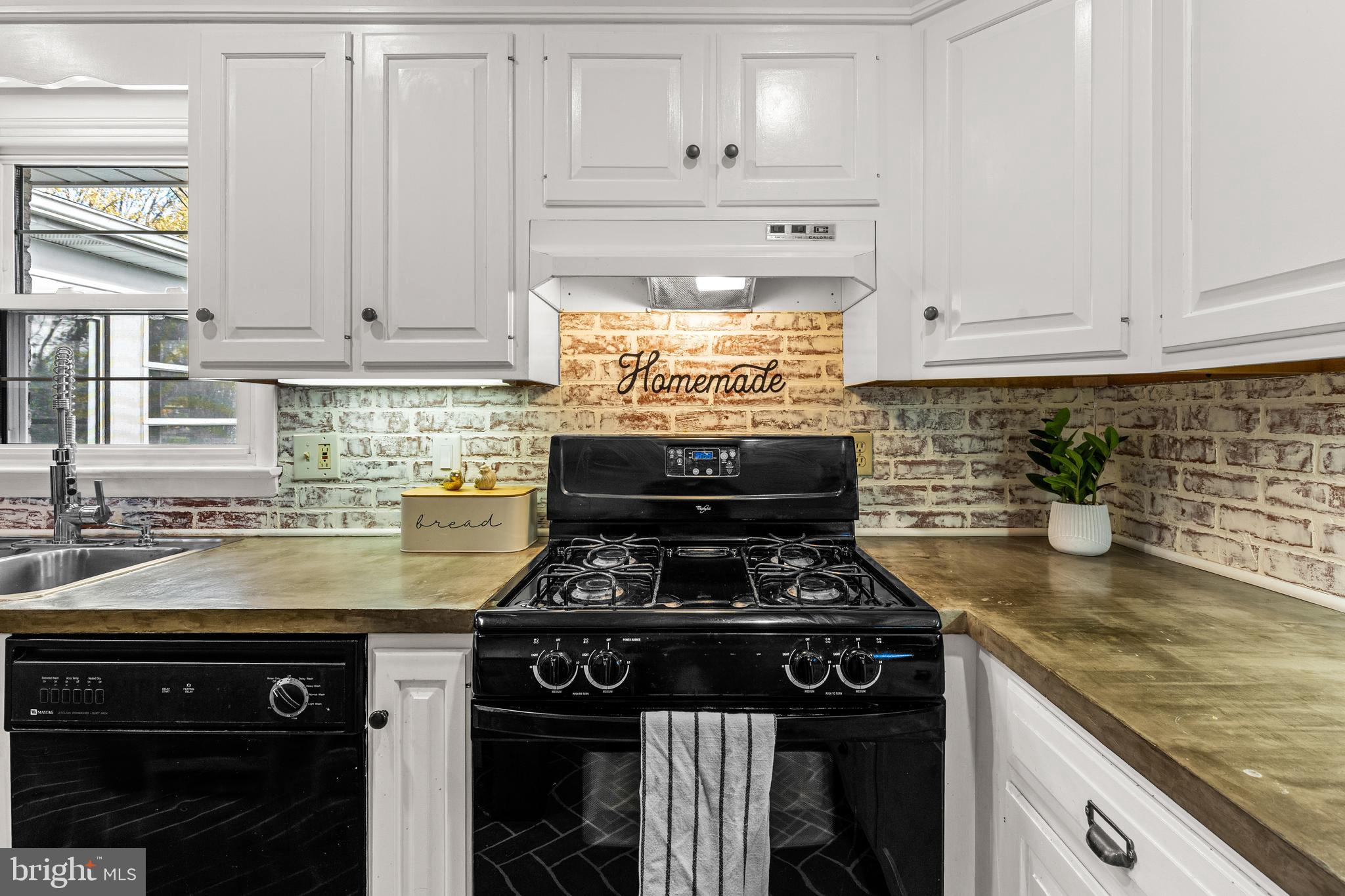 63 Quaker Hills Road Lancaster, PA 17603 - Photo 20 of 52 a kitchen with granite countertop a stove sink and cabinets