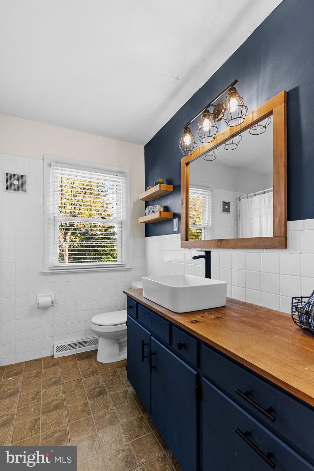 63 Quaker Hills Road Lancaster, PA 17603 - Photo 22 of 52 a bathroom with a sink a mirror and a toilet