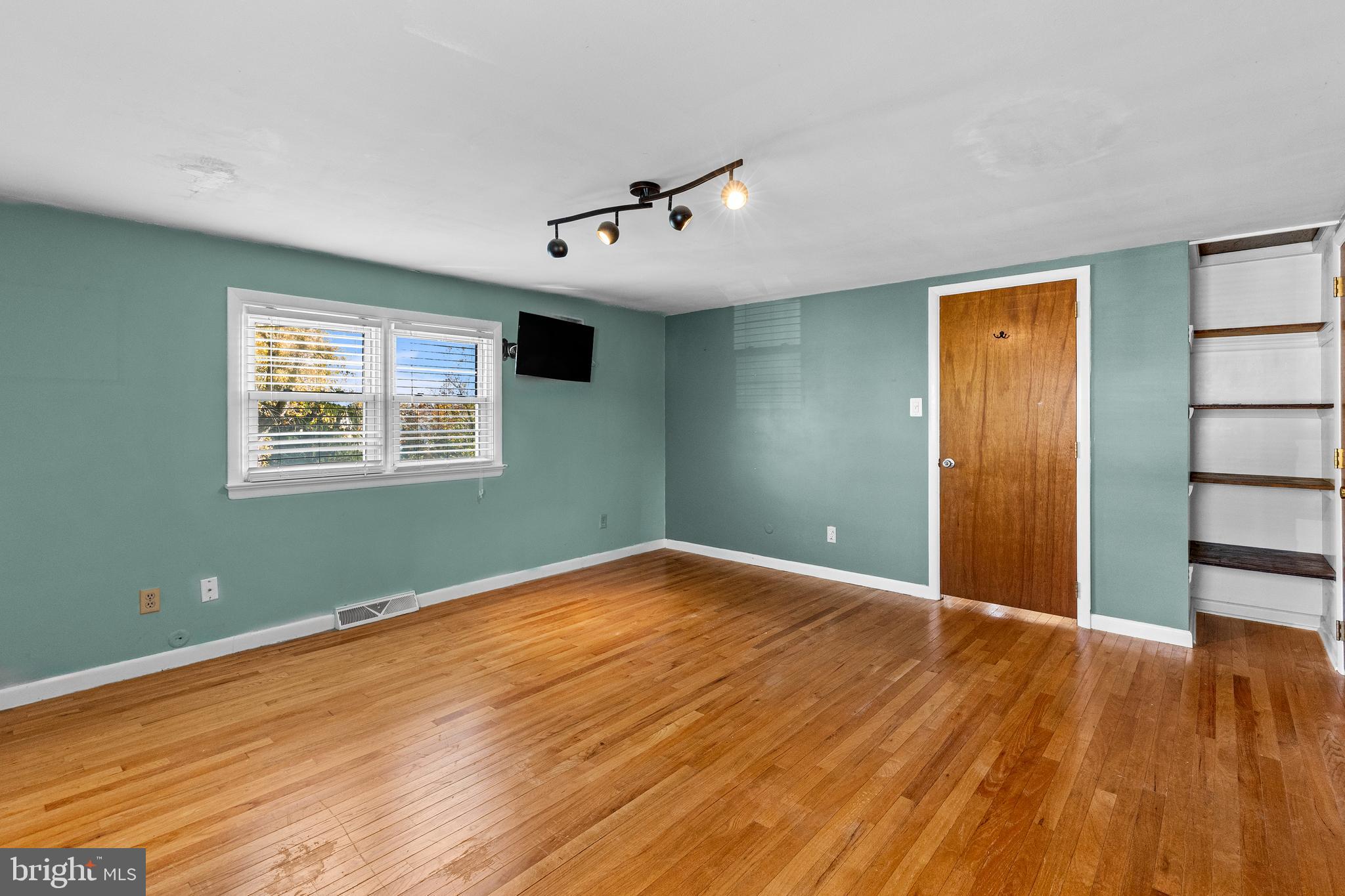 63 Quaker Hills Road Lancaster, PA 17603 - Photo 27 of 52 a view of an empty room with wooden floor and a window