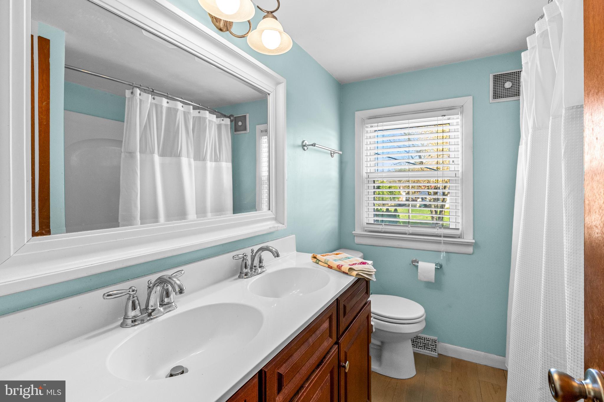 63 Quaker Hills Road Lancaster, PA 17603 - Photo 31 of 52 a bathroom with a sink a toilet and a mirror