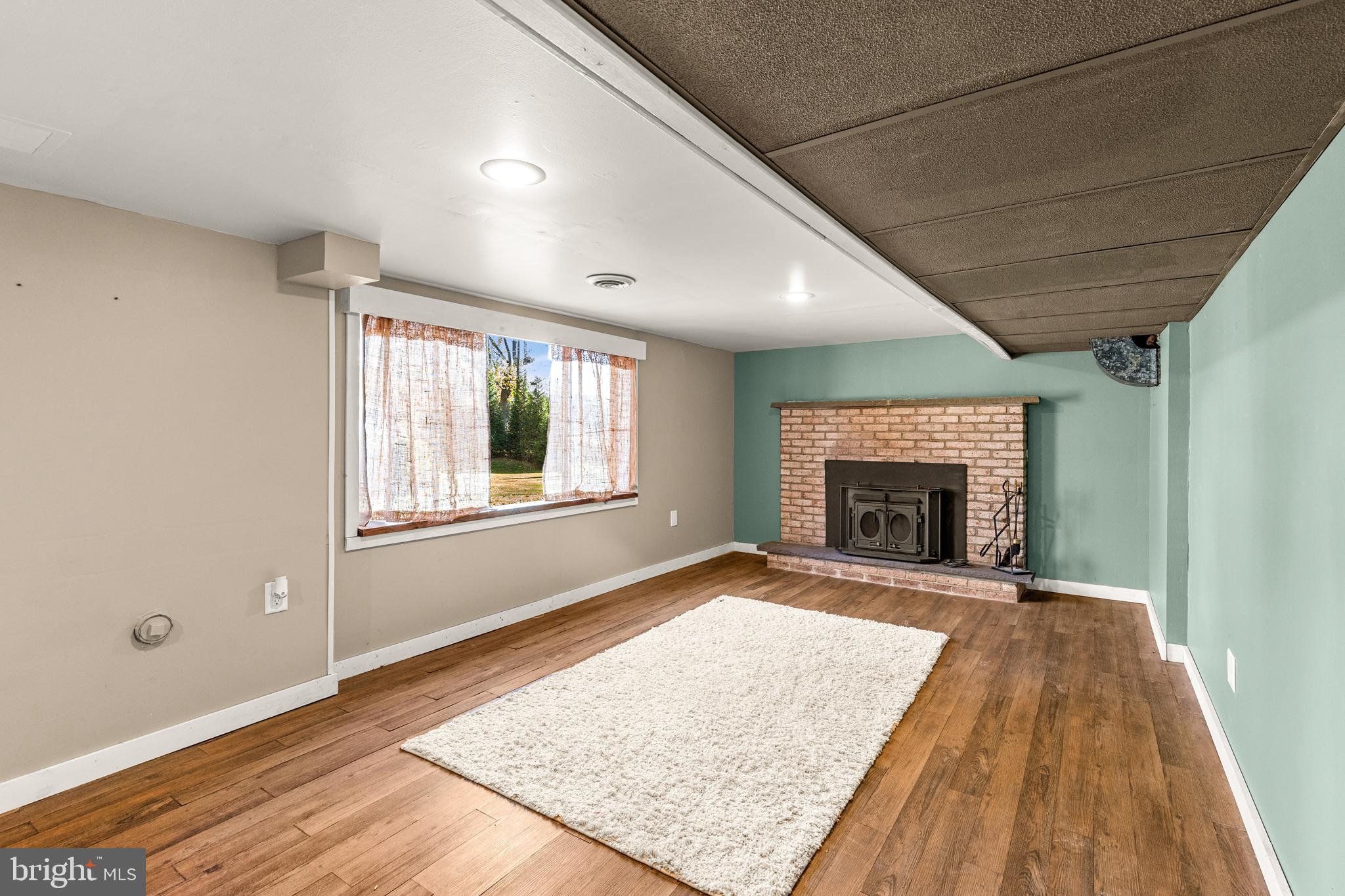 63 Quaker Hills Road Lancaster, PA 17603 - Photo 41 of 52 a view of empty room with wooden floor and fireplace