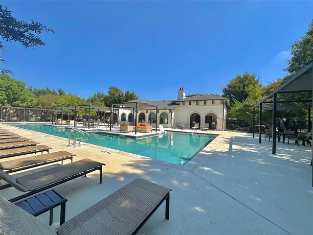 a view of a house with swimming pool and porch