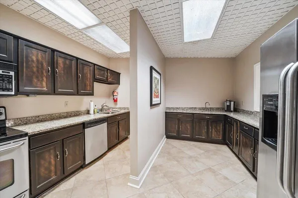a kitchen with stainless steel appliances granite countertop a stove and a refrigerator