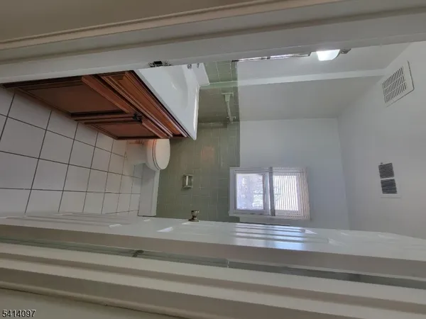 a view of an empty room and a window