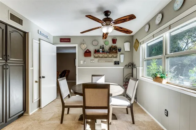 a dining room with furniture a floor to ceiling window and a large window