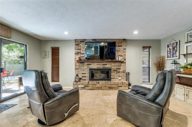 a living room with fireplace furniture and a flat screen tv