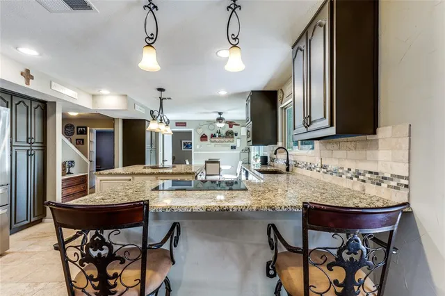 a kitchen with a table and chairs in it