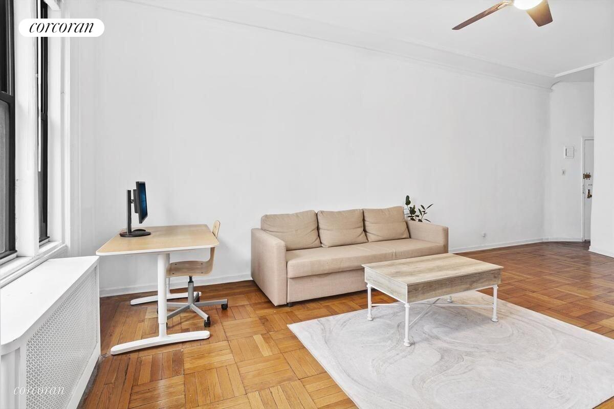 140 West 69th Street, Unit 103B Manhattan, NY 10023 - Photo 3 of 12 a living room with furniture and a table