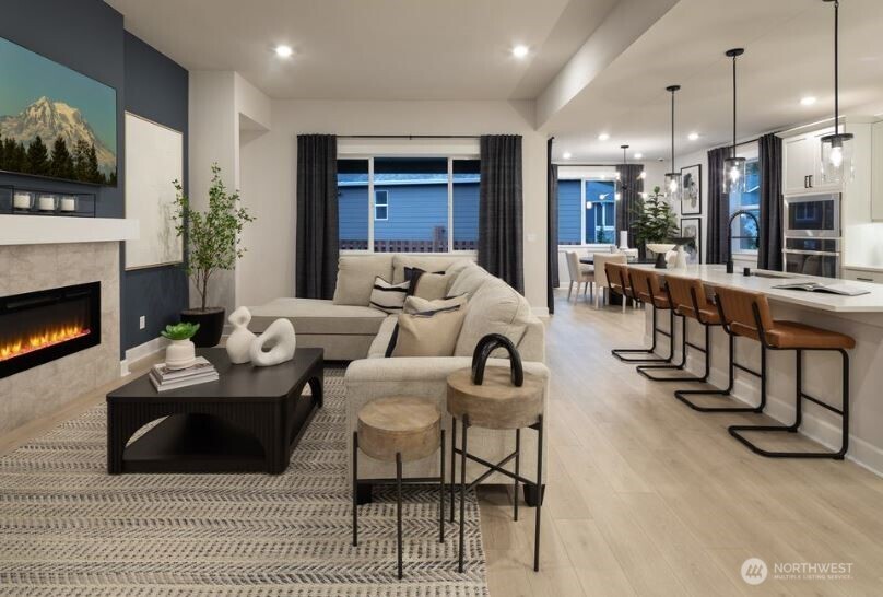 2526 Acer Loop Southeast Lacey, WA 98513 - Photo 11 of 19 a living room with furniture a flat screen tv and a fireplace