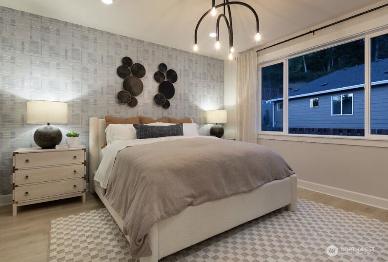 2526 Acer Loop Southeast Lacey, WA 98513 - Photo 12 of 19 a bedroom with a large bed and a chandelier