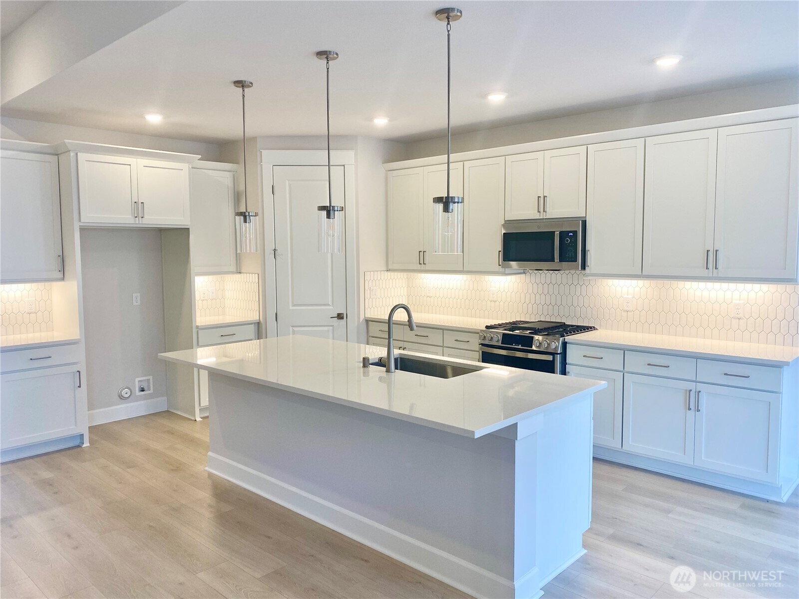 2526 Acer Loop Southeast Lacey, WA 98513 - Photo 2 of 19 a large kitchen with stainless steel appliances kitchen island granite countertop a sink a stove and a refrigerator
