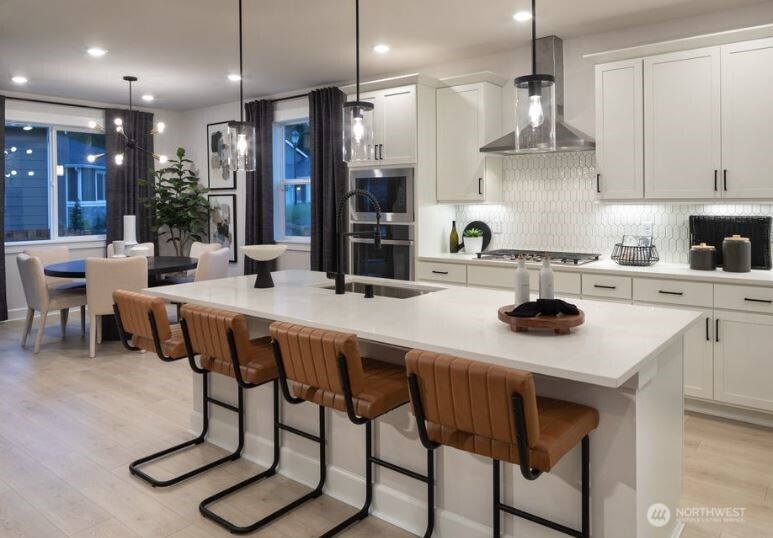 2526 Acer Loop Southeast Lacey, WA 98513 - Photo 7 of 19 a kitchen with stainless steel appliances granite countertop a sink a stove a refrigerator and chairs