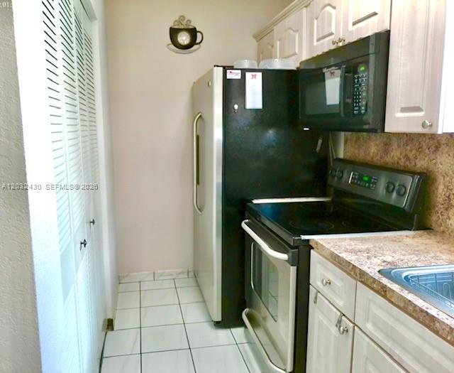 6527 West 22nd Lane Hialeah, FL 33016 - Photo 7 of 18 a kitchen with a stove sink and refrigerator