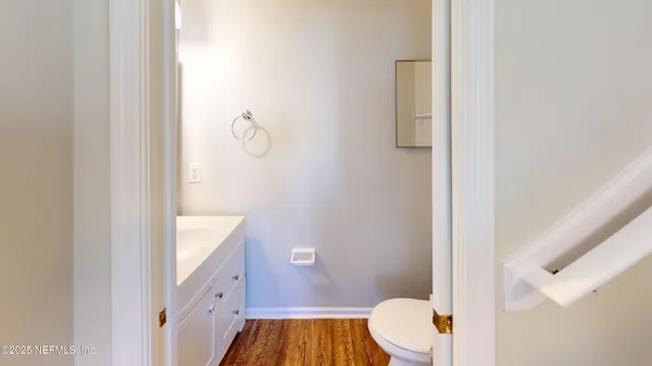 a bathroom with a toilet a sink and mirror