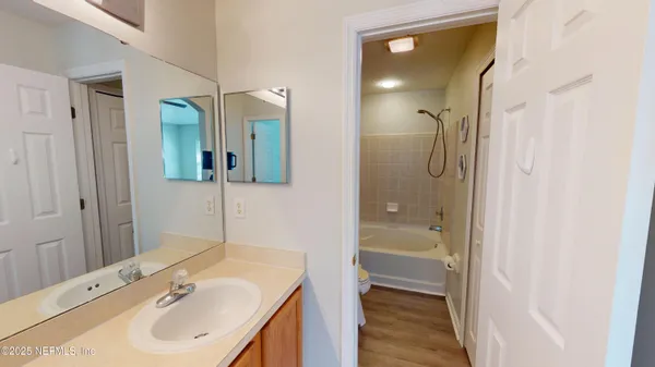 a bathroom with a sink a mirror and a shower
