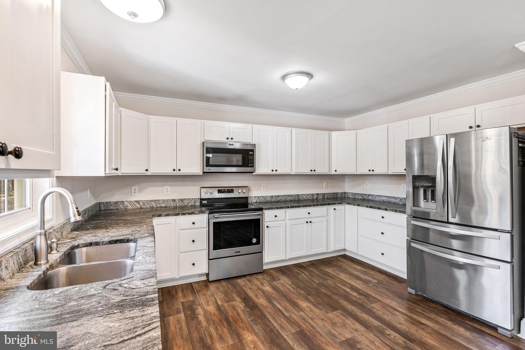 16352 Bullocks Road Ruther Glen, VA 22546 - Photo 11 of 29 a kitchen with granite countertop a sink stainless steel appliances and cabinets