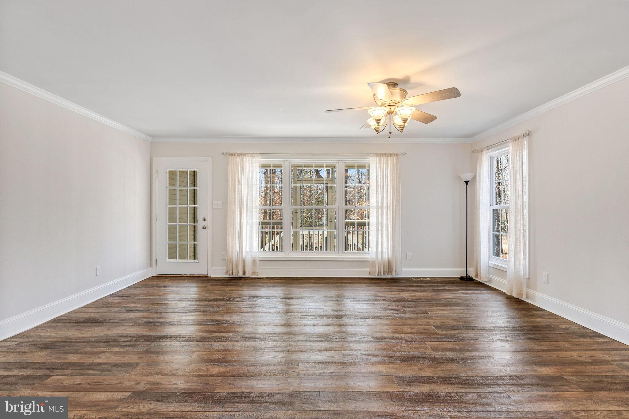 16352 Bullocks Road Ruther Glen, VA 22546 - Photo 13 of 29 a view of an empty room with wooden floor and a window