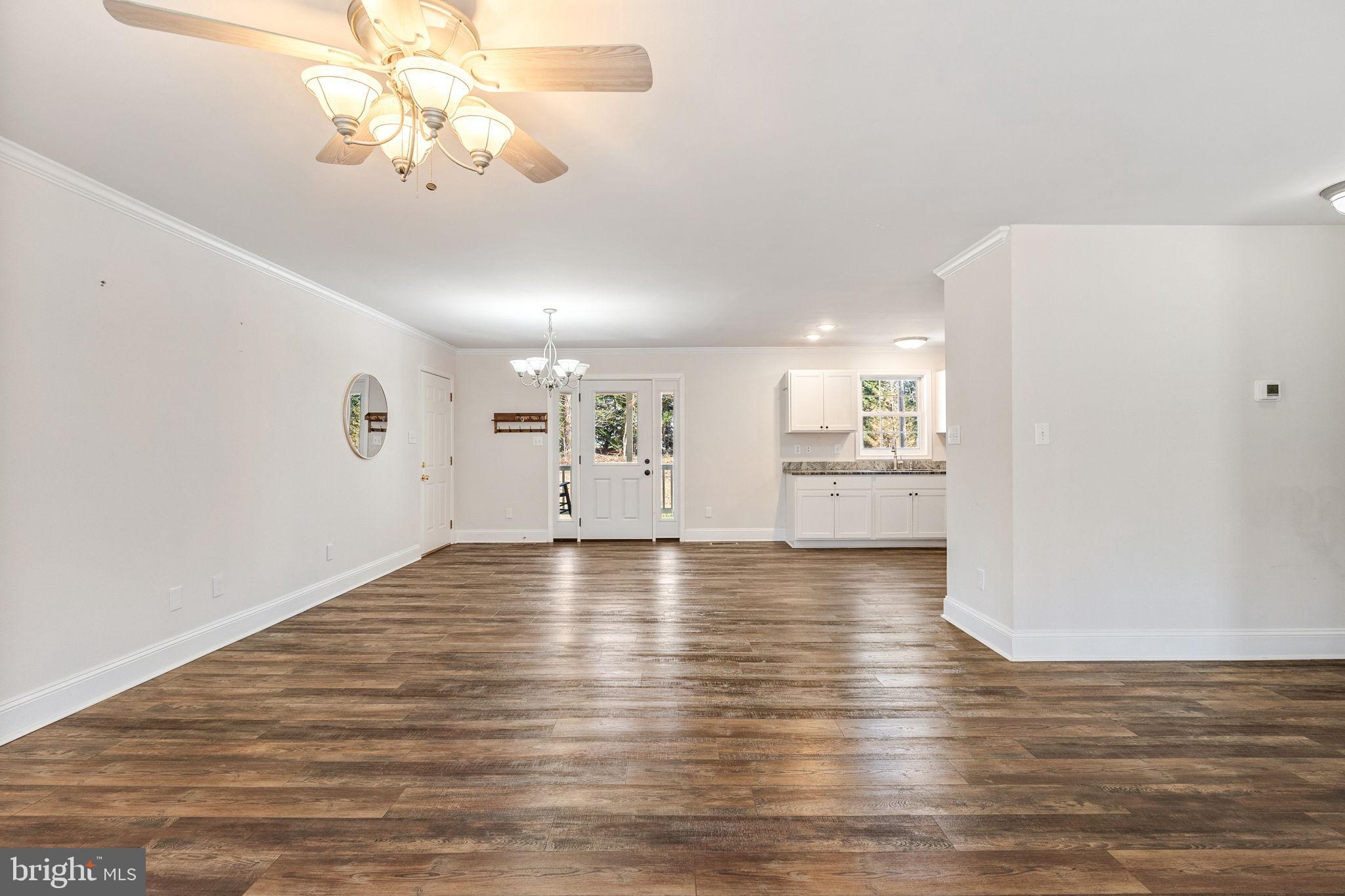 16352 Bullocks Road Ruther Glen, VA 22546 - Photo 14 of 29 a view of a room with wooden floor and kitchen view