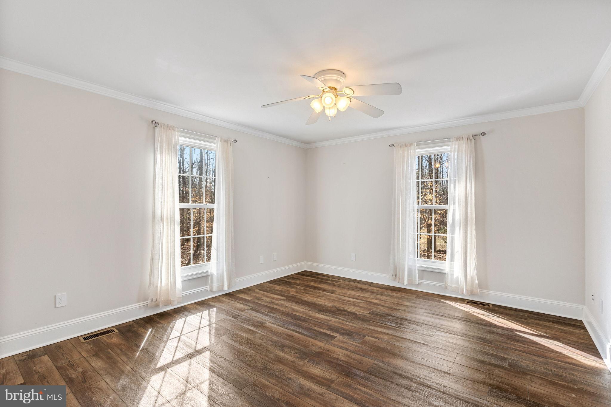 16352 Bullocks Road Ruther Glen, VA 22546 - Photo 18 of 29 a view of an empty room with a window and wooden floor