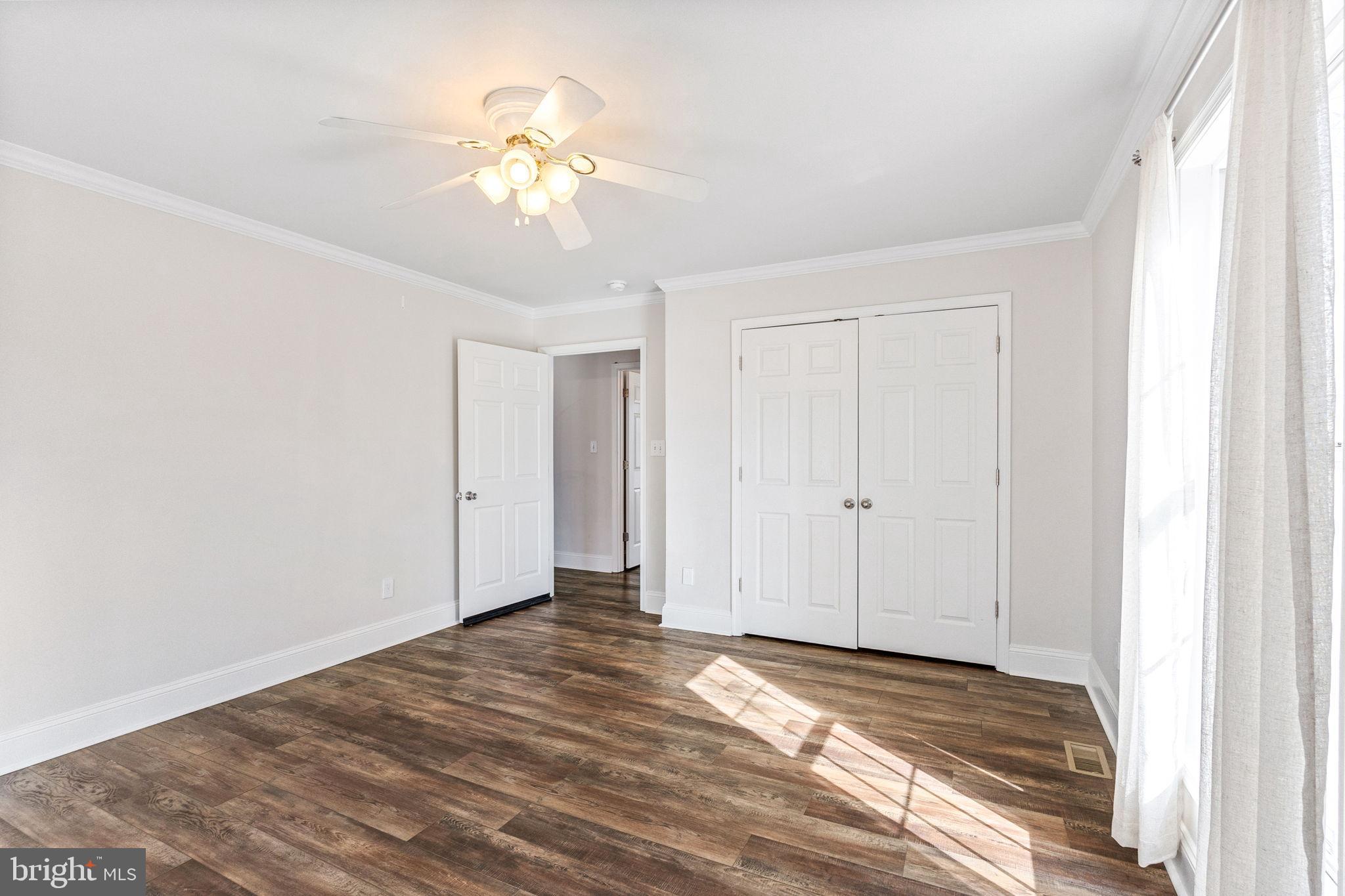16352 Bullocks Road Ruther Glen, VA 22546 - Photo 19 of 29 a view of a livingroom with wooden floor and a ceiling fan