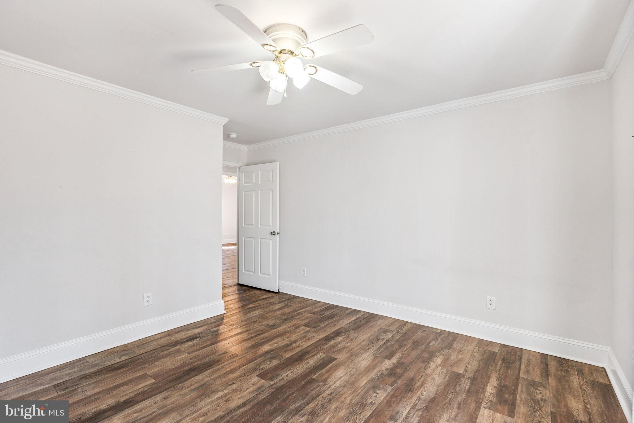 16352 Bullocks Road Ruther Glen, VA 22546 - Photo 21 of 29 an empty room with wooden floor and fan