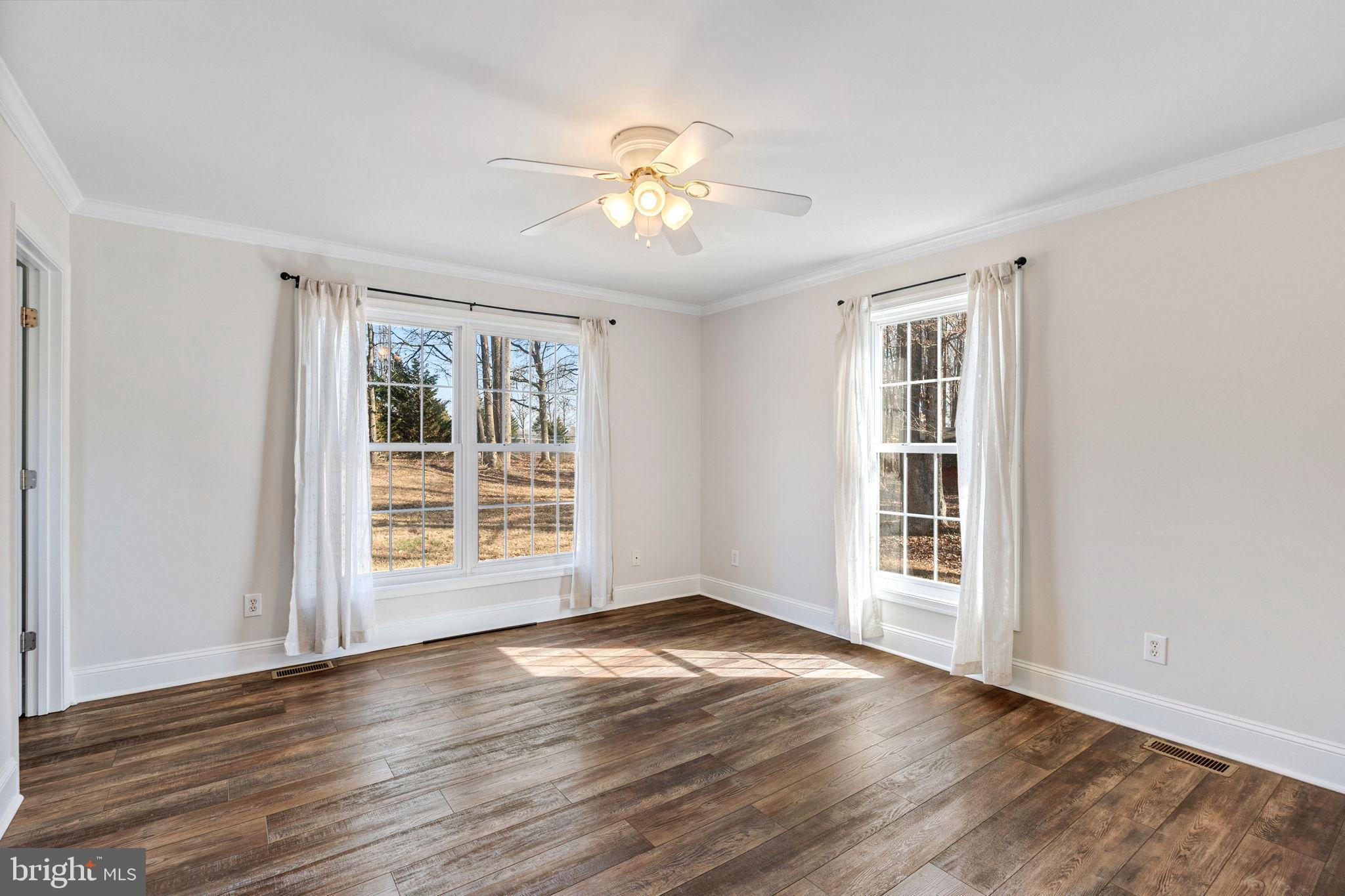 16352 Bullocks Road Ruther Glen, VA 22546 - Photo 22 of 29 a view of an empty room with a window and wooden floor