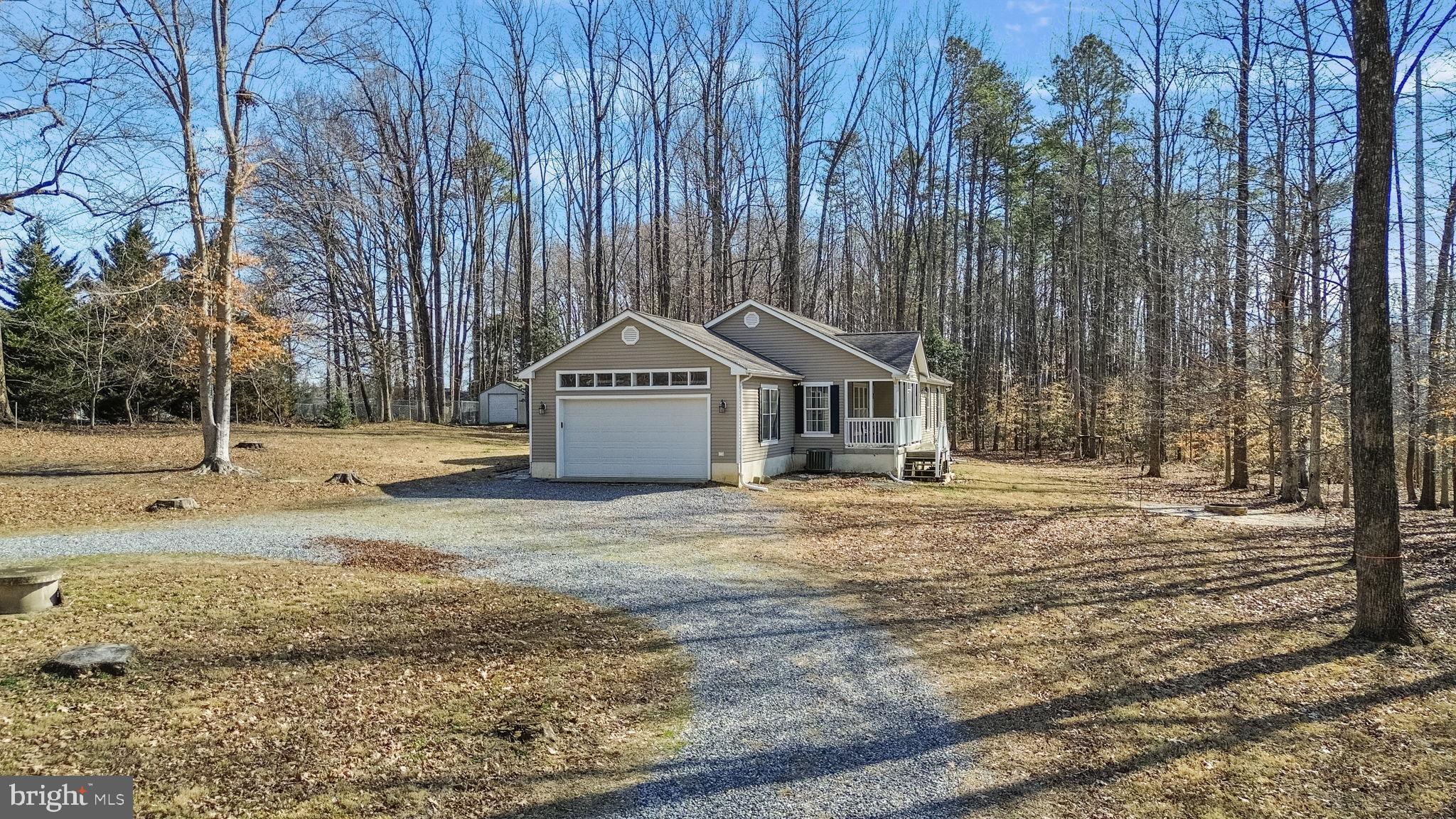 16352 Bullocks Road Ruther Glen, VA 22546 - Photo 3 of 29 a view of a house with backyard and trees